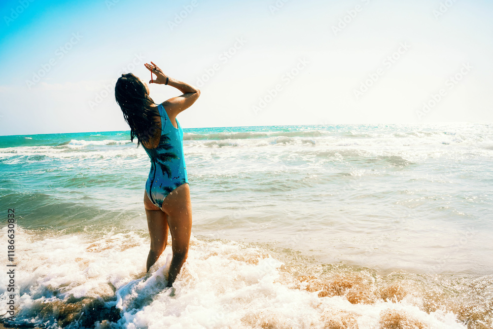 Girl in blue swimsuit on sea coast adjusts hair and enjoys rest. View from back. Generated image Girl in blue swimsuit on sea coast adjusts hair and enjoys rest. View from back. Generated image