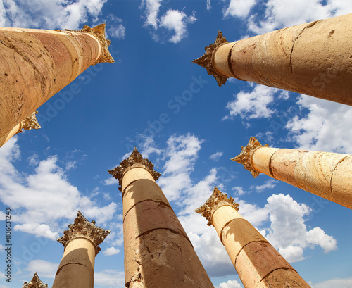 Roman Columns in the Jordanian city of Jerash (Gerasa of Antiquity), capital and largest city of Jerash Governorate, Jordan. Against the background of a beautiful sky with clouds photo