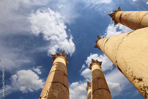 Roman Columns in the Jordanian city of Jerash (Gerasa of Antiquity), capital and largest city of Jerash Governorate, Jordan. Against the background of a beautiful sky with clouds photo