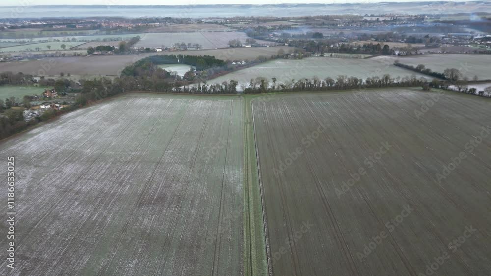 Descending Drone shot over arable farmland on a frosty morning in January, a view looking north over the Weald of Kent, UK Descending Drone shot over arable farmland on a frosty morning in January, a view looking north over the Weald of Kent, UK
