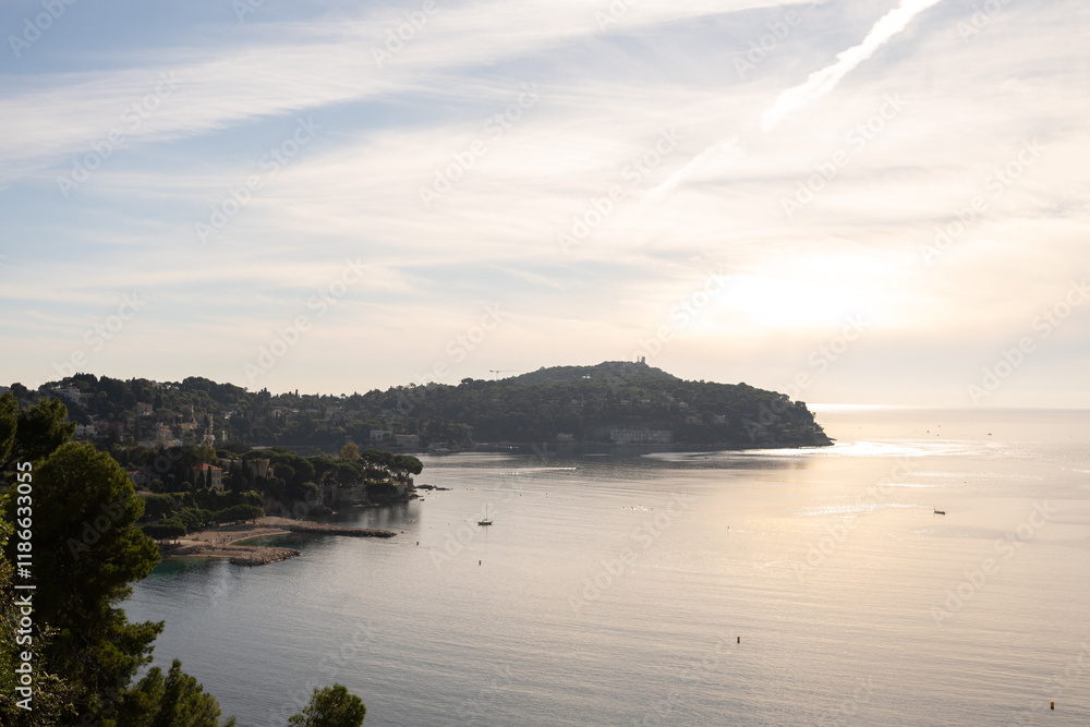 Fototapeta premium Aerial view of peaceful coastal landscape near Nice, France, with serene waters and distant hills. Concept of Mediterranean tranquility, nature, and scenic beauty. Luxury travel vacation destinations.