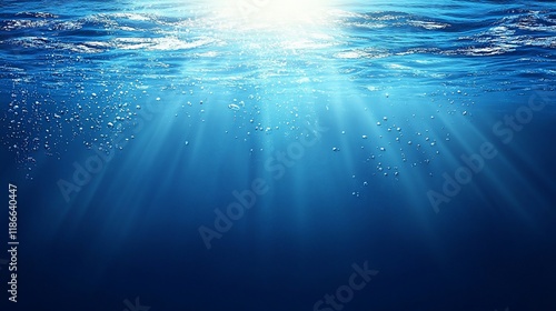 Underwater scene with sun rays, bubbles, and deep blue water.