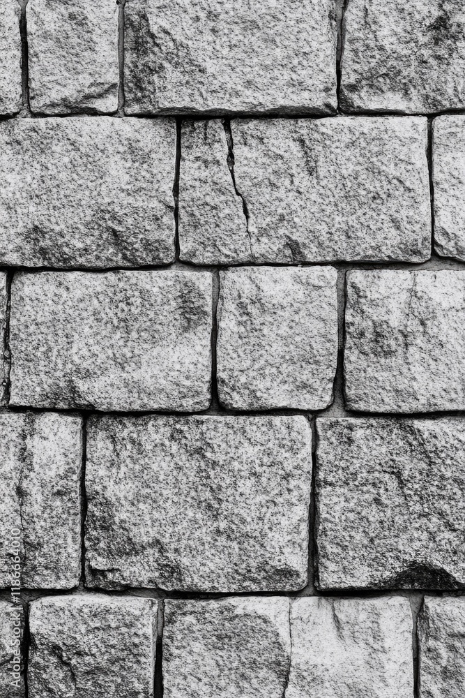 Fototapeta premium A close-up shot of a worn-out brick wall in monochrome