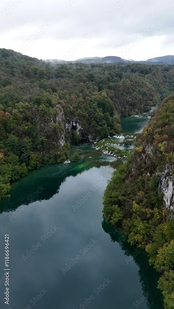 Aerial journey over serene lake and forest landscape Aerial journey over serene lake and forest landscape