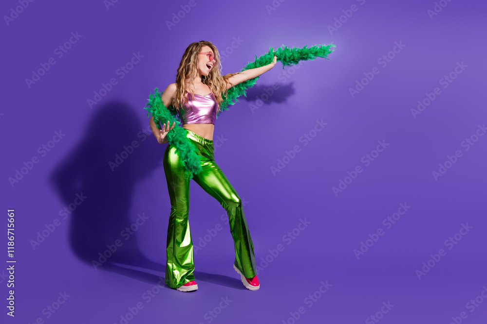 Vibrant young woman in retro style with shiny outfit and boa on purple background Vibrant young woman in retro style with shiny outfit and boa on purple background