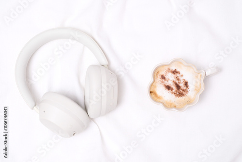 Stilish headphones, cup of coffee on white background. Time for relaxing. photo