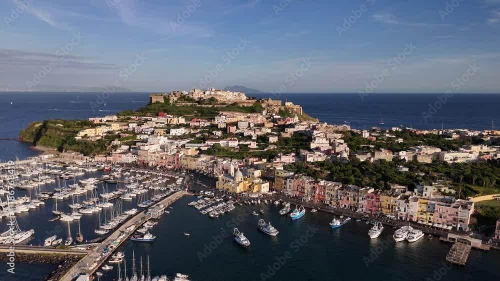 Aerial journey over scenic coastal town and harbor at sunset Aerial journey over scenic coastal town and harbor at sunset