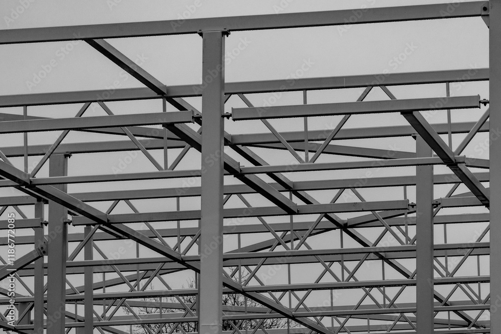 Modern Steel Frame of Industrial Building Under Construction. Geometric Steel Structure Framework in Progress. Modern Steel Frame of Industrial Building Under Construction. Geometric Steel Structure Framework in Progress.