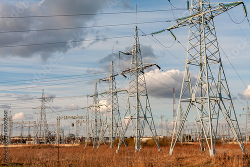 Electric Power Transmission Lines Across Rural Landscape Under a Blue Sky