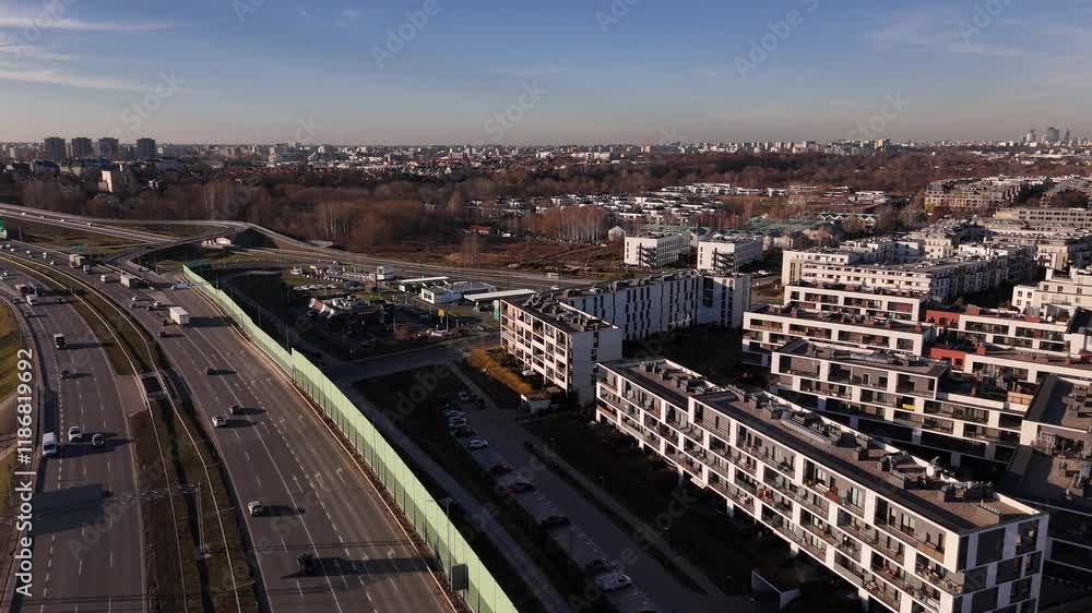 Aerial view of urban cityscape with busy roads and residential buildings under blue sky Aerial view of urban cityscape with busy roads and residential buildings under blue sky