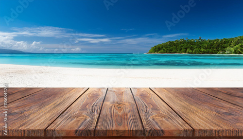 pinnacle of the wood table iin the front of the white beach photo