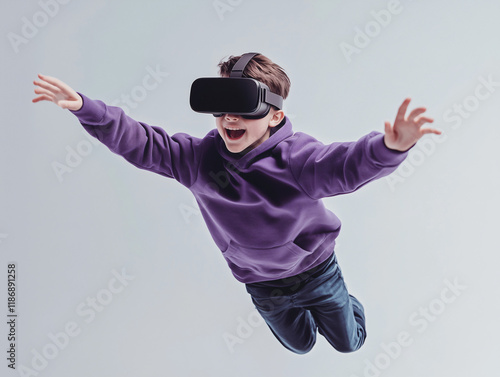 Virtual Reality Flight: A young boy wearing a VR headset, eyes wide with excitement, leaps into the air with outstretched arms, his virtual reality experience taking him on a thrilling journey. photo