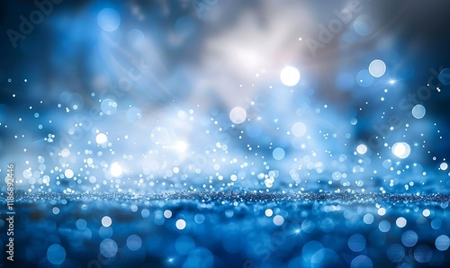 Enchanting blue and white bokeh lights create a luminous effect on a dark gradien