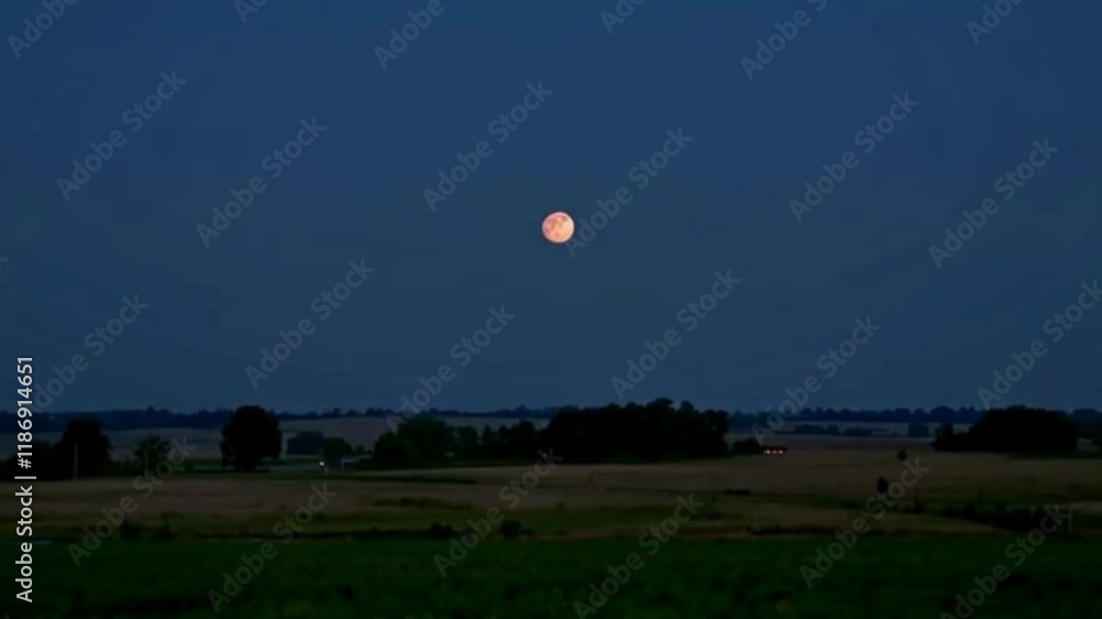 The Moon Rising Over a Calm Rural Landscape The Moon Rising Over a Calm Rural Landscape