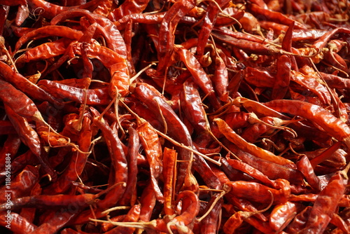 A heap of dry red chili pepper is displayed in a spice market, Dried spicy red chilies are on sale, Showcase of spicy red chili in a spice shop in Asia for the spice trade