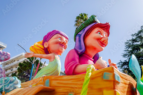 Two Giant Female Figures at the Annual  Carnival of Patras, Greece. Colorful Sculptures on a Carnaval Float Ready for the Traditional Parade. Beautiful Handmade Statues with Blue Sky in Background.