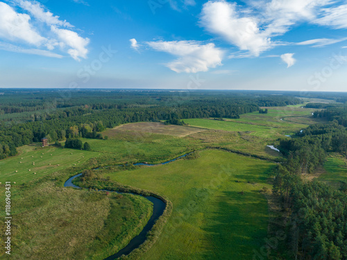 Aerial viev rural landscape and Ina river near Puszcza Goleniowska in West Pomerania, region of Poland. Photo from the drone.	
