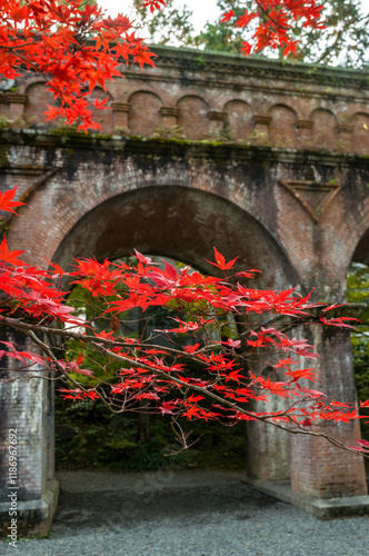 Nanzen Ji Temple acquaduct with autumn maple leaves in Kyoto photo