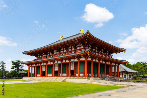 Kofuku-ji Temple in Nara, Japan with Vibrant Red and Gold Architecture under a Bright Blue Sky