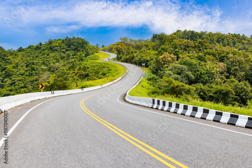 Popular view point of double s-curve road up to the hill with green tree and sky, called curve number 3 at Nan province, Northern of Thailand