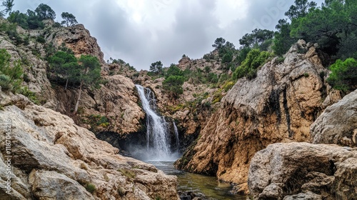Stunning waterfall cascading through rocky highlands under an overcast sky surrounded by lush greenery and rugged terrain