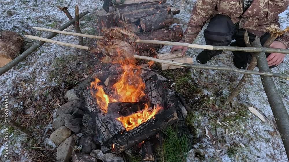Chicken roasting on a fire in a winter forest Chicken roasting on a fire in a winter forest