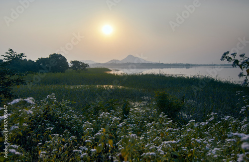 start of a new day as sun rises against backdrop of hilly landscape in Baranti (or Barhanti) village, Purulia district. Warm golden lights have created a scenic natural beauty in a winter dawn. photo