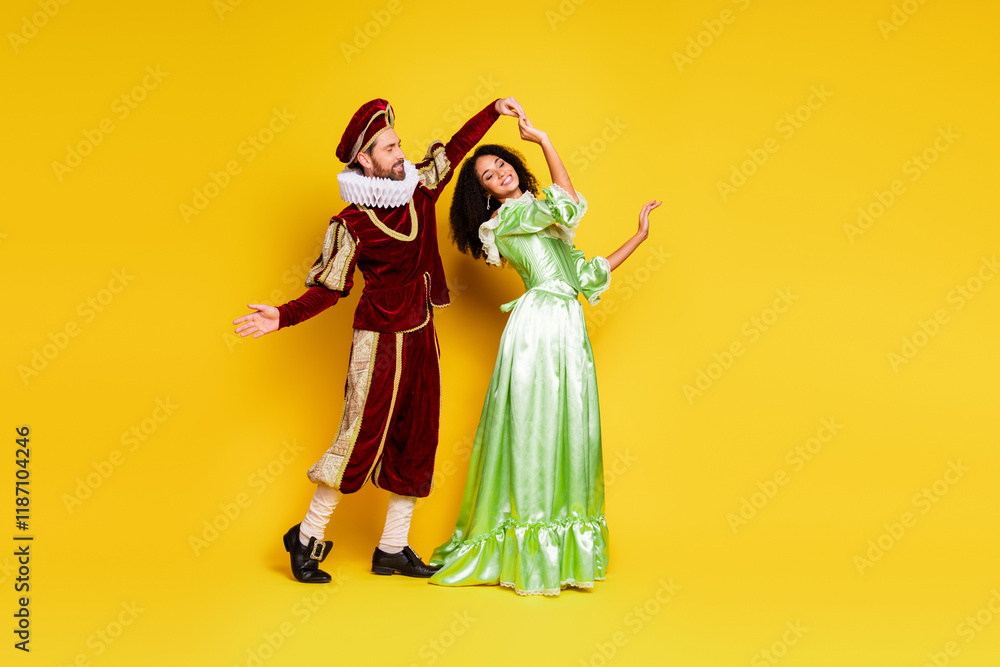 Fototapeta premium Couple in Elegant Retro Costumes Posing on Yellow Background in Theme Party Style