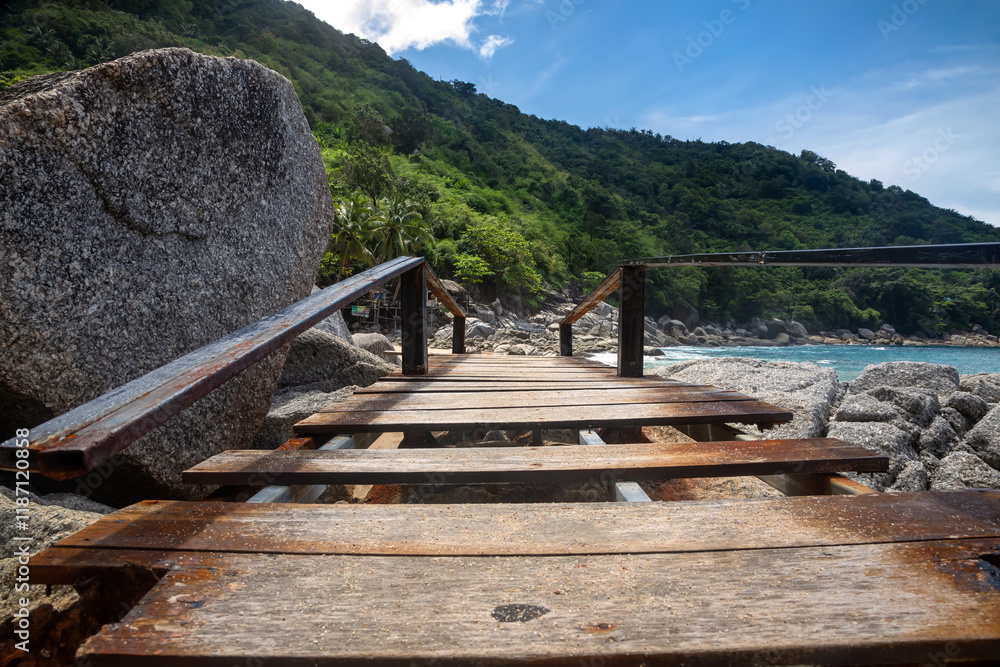 Fototapeta premium Wooden bridge on a sunny beach. Beautiful empty beach. Sunny summer day.