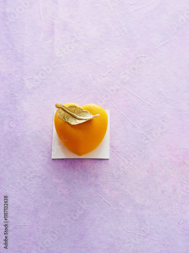 Delicious Heart-Shaped Dessert With a Leaf Garnish on a Pastel Background photo