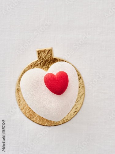 Delicious Modern Dessert With Red Heart Decoration Presented on Elegant White Fabric
