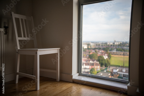 Empty room, chair, city view.