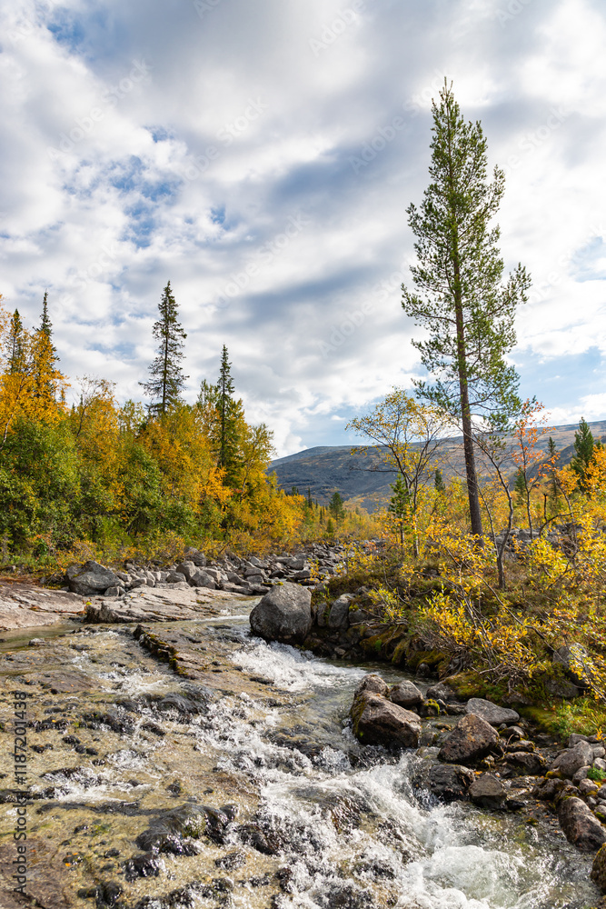View to Mannepakhp river at Khibiny mountains. Early autumn in arctic tundra region. Kola peninsula, Murmansk region, Russia. View to Mannepakhp river at Khibiny mountains. Early autumn in arctic tundra region. Kola peninsula, Murmansk region, Russia.
