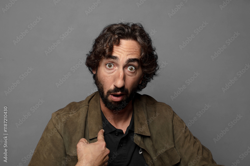 Fototapeta premium looking shocked and surprised with mouth wide open, pointing to self