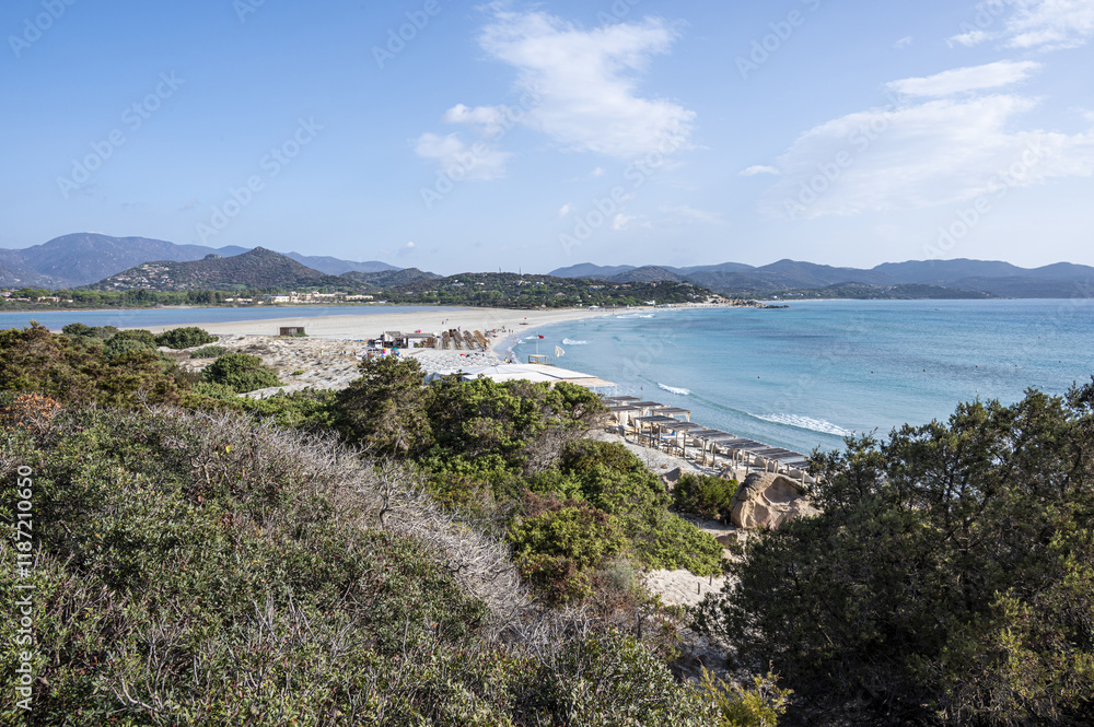VIllasimius, Italy - 09-05-2024: Aerial view of the beautiful beach of Porto Giunco in Villasimius with white sand and crystal clear water with the Notteri pond in the background