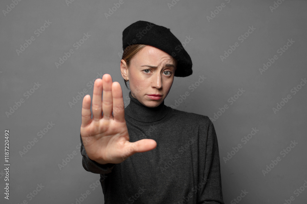 looking serious, stern, displeased and angry showing open palm making stop gesture looking serious, stern, displeased and angry showing open palm making stop gesture