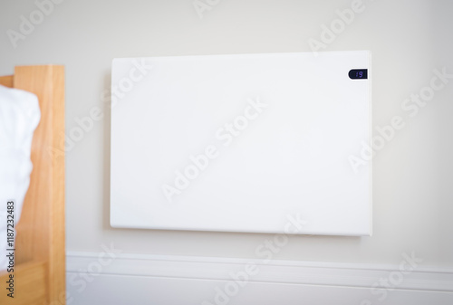 Electric heating panel radiator on a bedroom wall, UK home