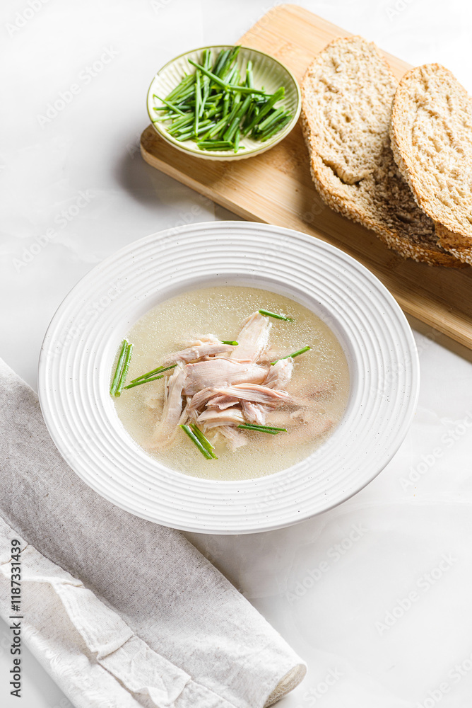 chicken broth in a white bowl with chicken chicken broth in a white bowl with chicken
