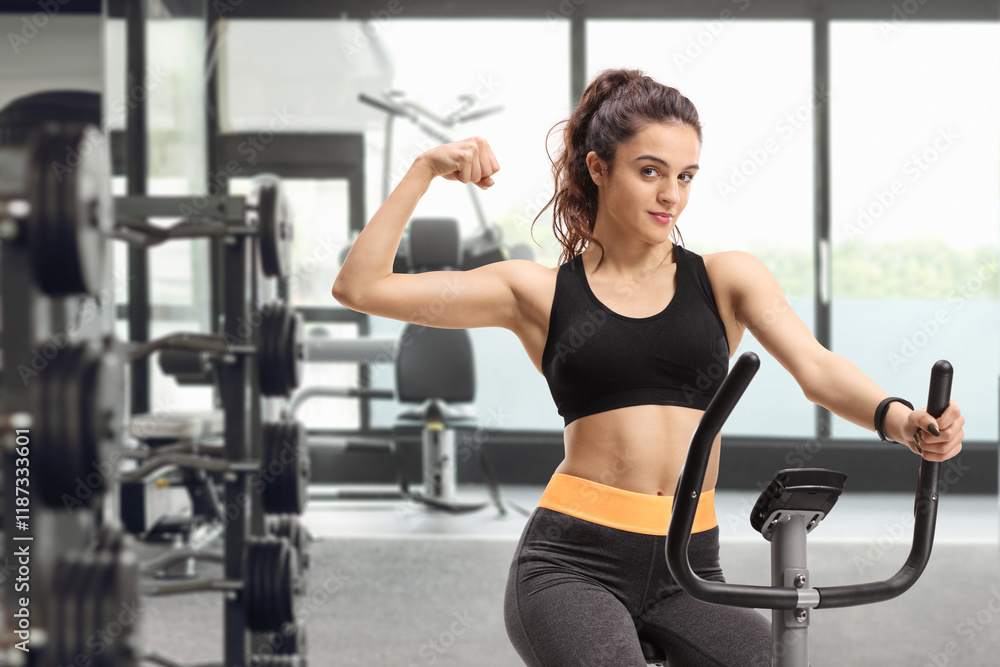 Fototapeta premium Young female exercising on a bike