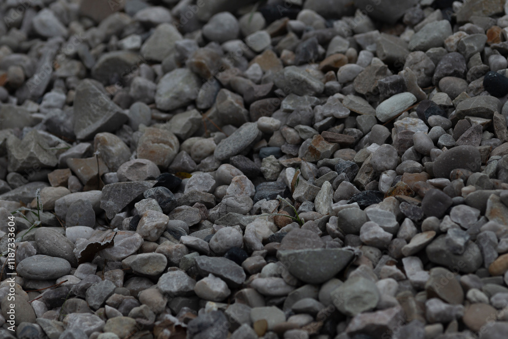 A closeup view of gravel showcasing a variety of stone sizes and shades that can be used for construction, landscaping, or other purposes A closeup view of gravel showcasing a variety of stone sizes and shades that can be used for construction, landscaping, or other purposes