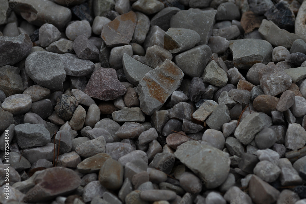 A closeup view of gravel showcasing a variety of stone sizes and shades that can be used for construction, landscaping, or other purposes A closeup view of gravel showcasing a variety of stone sizes and shades that can be used for construction, landscaping, or other purposes