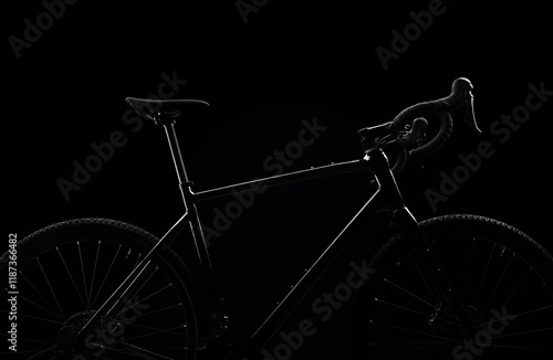 Silhouette of black bicycle on black background.