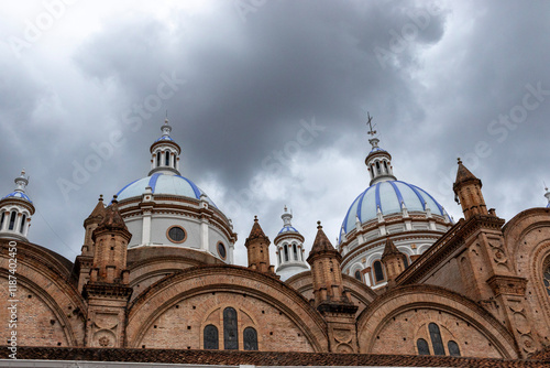 Cuenca cathedral's majestic domes rising under cloudy sky in ecuador photo