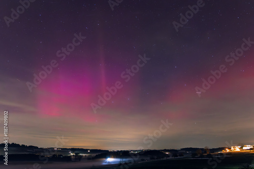 Bright Pink Aurora Borealis Over Countryside in mid Altitude, Switzerland, Europe photo