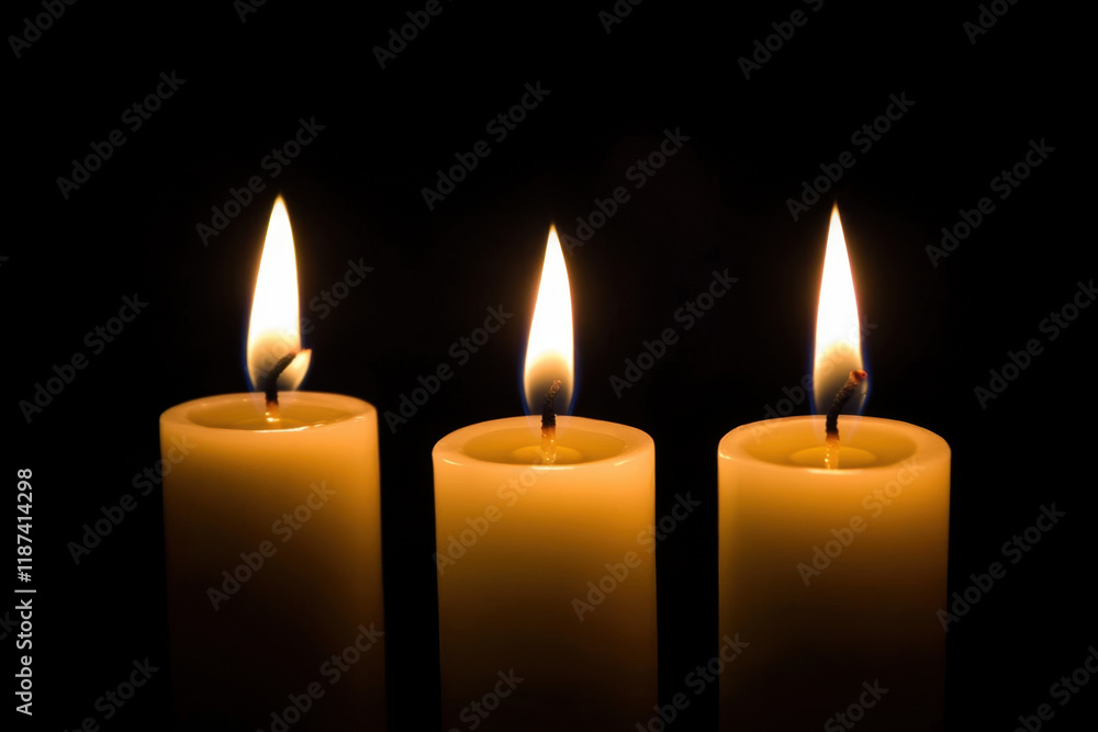 yellow candle lit on black background.
yellow candle lit on black background.