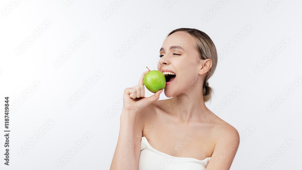 Happy woman biting Green Apple Posing Over White Background. Healthy nutrition, diet food Concept. Studio Shot, Isolated. Beauty health care lifestyle. Free copy space, banner. Stomatology concept. Happy woman biting Green Apple Posing Over White Background. Healthy nutrition, diet food Concept. Studio Shot, Isolated. Beauty health care lifestyle. Free copy space, banner. Stomatology concept.