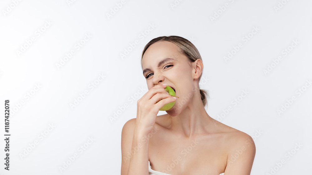 Happy woman biting Green Apple Posing Over White Background. Healthy nutrition, diet food Concept. Studio Shot, Isolated. Beauty health care lifestyle. Free copy space, banner. Stomatology concept. Happy woman biting Green Apple Posing Over White Background. Healthy nutrition, diet food Concept. Studio Shot, Isolated. Beauty health care lifestyle. Free copy space, banner. Stomatology concept.
