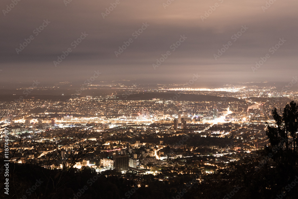 Illuminated Cityscape at Night with Cloudy Sky in Zurich, Switzerland Illuminated Cityscape at Night with Cloudy Sky in Zurich, Switzerland