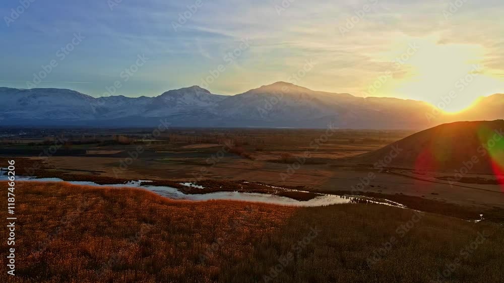 Aerial view video of a mountain range at sunrise, with golden light illuminating the peaks and valleys. Perfect for nature, adventure, and landscape-themed projects. Aerial view video of a mountain range at sunrise, with golden light illuminating the peaks and valleys. Perfect for nature, adventure, and landscape-themed projects.