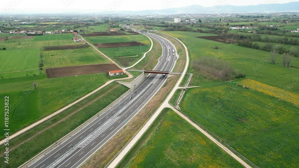 Aerial View of a Countryside Highway Surrounded by Lush Green Fields, Creating a Serene Environment Aerial View of a Countryside Highway Surrounded by Lush Green Fields, Creating a Serene Environment